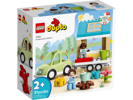 Set the main image alt text to: "LEGO DUPLO Family House on Wheels 10986 building kit with car, trailer, campfire, and 2 figures"